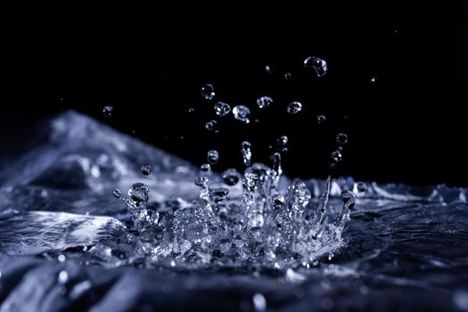 Water drops splashing on acoustic membrane. A lot of drops in air. High frequency of sound waves. Water cloud small drops. Frozen time shot. 