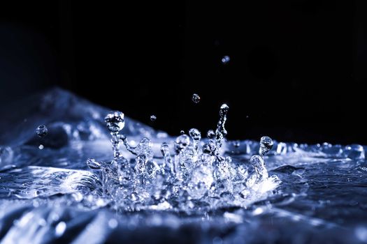 Water drops splashing on acoustic membrane. A lot of drops in air. High frequency of sound waves. Water cloud small drops. Frozen time shot.