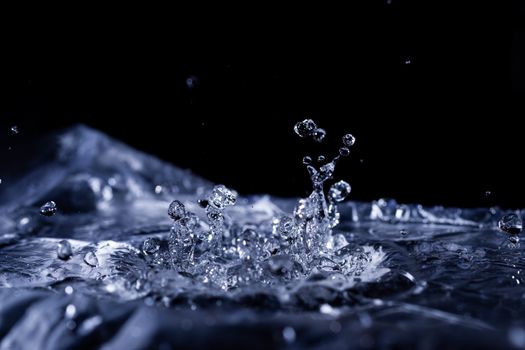 Water drops splashing on acoustic membrane. A lot of drops in air. High frequency of sound waves. Water cloud small drops. Frozen time shot. 
