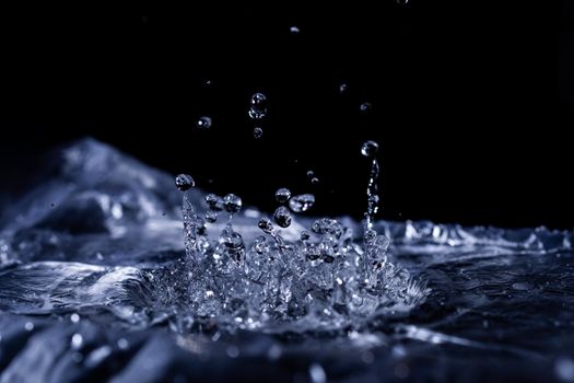 Water drops splashing on acoustic membrane. A lot of drops in air. High frequency of sound waves. Water cloud small drops. Frozen time shot.