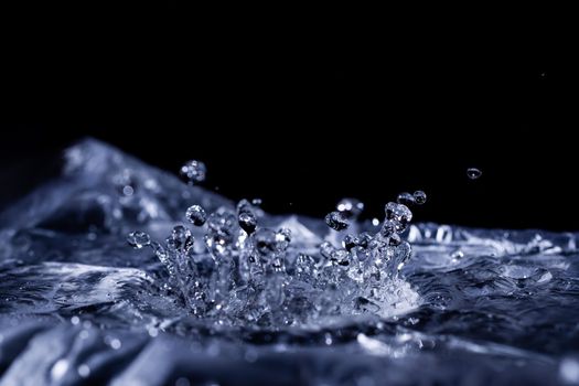 Water drops splashing on acoustic membrane. A lot of drops in air. High frequency of sound waves. Water cloud small drops. Frozen time shot. 