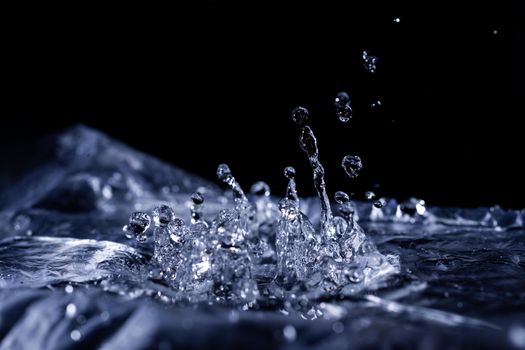Water drops splashing on acoustic membrane. A lot of drops in air. High frequency of sound waves. Water cloud small drops. Frozen time shot. 