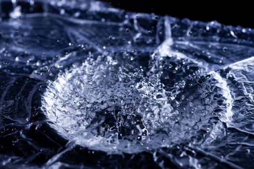 Water drops splashing on acoustic membrane. A lot of drops in air. High frequency of sound waves. Water cloud small drops. Frozen time shot.