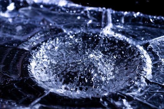 Water drops splashing on acoustic membrane. A lot of drops in air. High frequency of sound waves. Water cloud small drops. Frozen time shot.