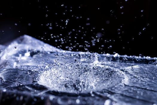 Water drops splashing on acoustic membrane. A lot of drops in air. High frequency of sound waves. Water cloud small drops. Frozen time shot.