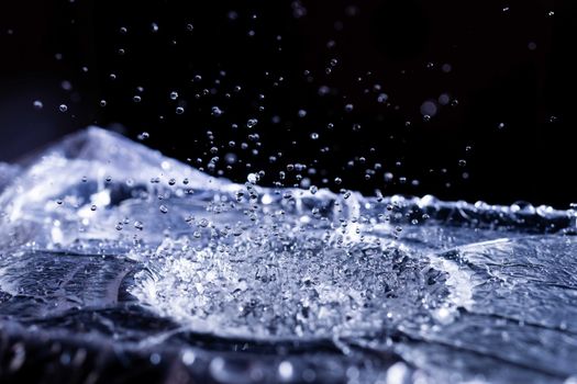 Water drops splashing on acoustic membrane. A lot of drops in air. High frequency of sound waves. Water cloud small drops. Frozen time shot.