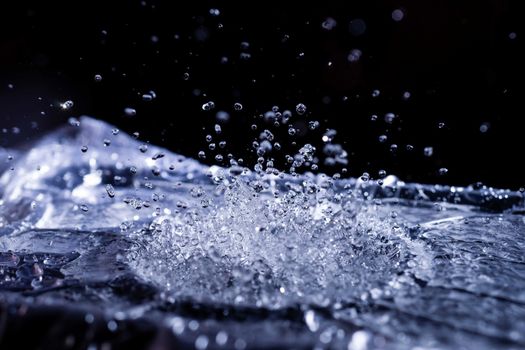 Water drops splashing on acoustic membrane. A lot of drops in air. High frequency of sound waves. Water cloud small drops. Frozen time shot.