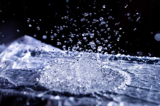 Water drops splashing on acoustic membrane. A lot of drops in air. High frequency of sound waves. Water cloud small drops. Frozen time shot.