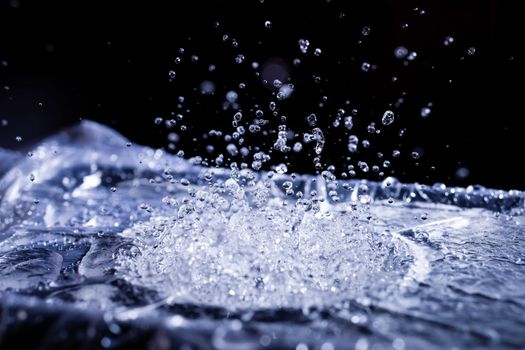 Water drops splashing on acoustic membrane. A lot of drops in air. High frequency of sound waves. Water cloud small drops. Frozen time shot.