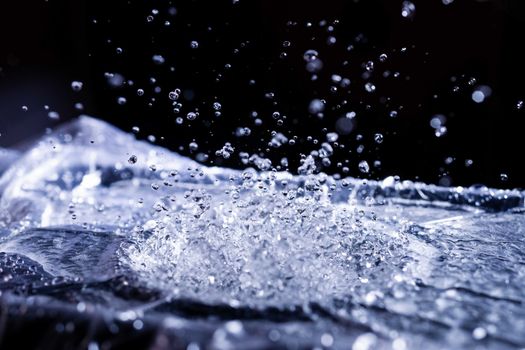 Water drops splashing on acoustic membrane. A lot of drops in air. High frequency of sound waves. Water cloud small drops. Frozen time shot.
