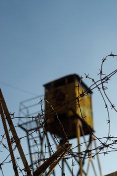Barbed wire and watchtower of the military unit