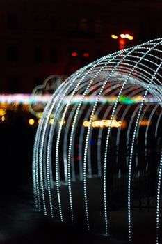 Vertical Christmas garland wall. Light is white and defocused. Blurred background, new year mood.