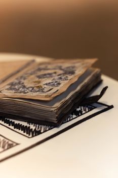 Handmade magic notebook with tower symbol on cover. Leather cover and handmade sheets inside. Notebook have 12 signs of the zodiac on first page. Very blurred background with soft focus on notebook.