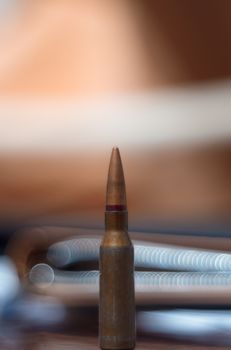 Rifle ammo on blurred background. Close-up view.
