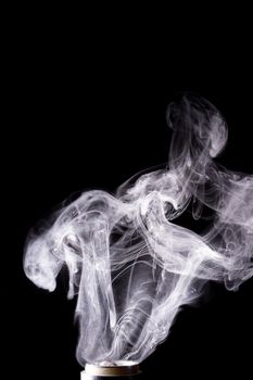 Vape clouds splash on black background. Stock isolated white smoke with spray boiling glycerine.