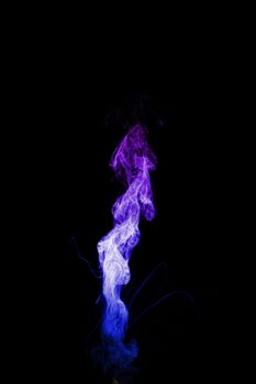 Dual colour vape steam column with spray boiling liquid. Blue and purple colour smoke. Stock photo isolated on black background.