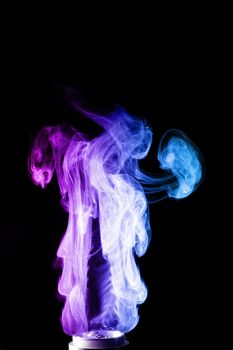 Colored clouds of vape smoke. A lot of colour and glicerine clouds, red and blue colours. Stock photo isolated on black background with boling spray of vaping liquid. Vape culture and no smoking movement.