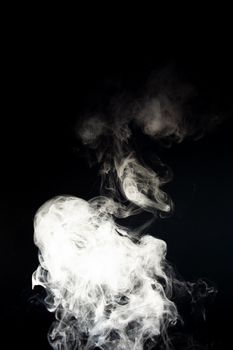 Vape steam spread with spray boiling liquid. Stock photo isolated on black background. Vape culture outreach. Conceptual image.