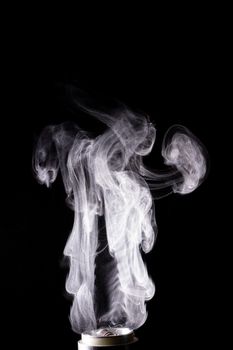 Vape clouds splash on black background. Stock isolated white smoke with spray boiling glycerine.