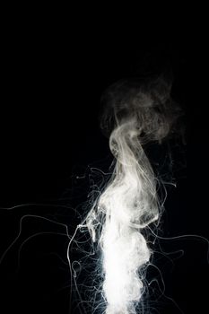 Column of vape clouds splash on black background. A lot of lines of smoke. White fog is tight. Stock isolated white smoke with spray boiling liquid.