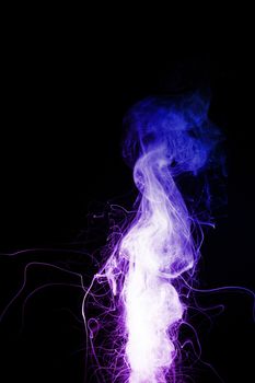 Column of vape clouds splash on black background. A lot of lines of smoke. Two colours fog is blue and purple. Stock isolated color smoke with spray boiling liquid.