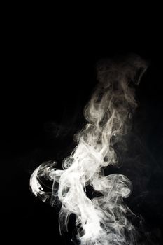 Vape steam spread with spray boiling liquid. Stock photo isolated on black background. Vape culture outreach. Conceptual image.