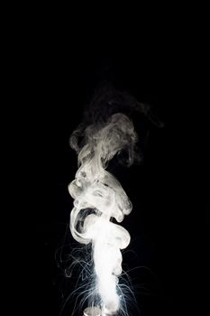 Column of vape clouds splash on black background. A lot of lines of smoke. White fog is tight. Stock isolated white smoke with spray boiling liquid.