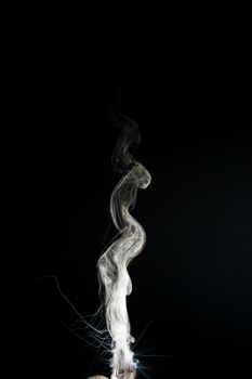 Column of vape clouds splash on black background. A lot of lines of smoke. White fog is tight. Stock isolated white smoke with spray boiling liquid.