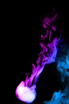 Round colored ring of vape fog on black background. Thick smoke bicolor ring goes down. Blue and purple color steam. Vape culture and no smoking direction.