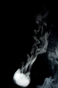 Round ring of vape fog on black background. At right side thick smoke ring goes down.. Vape culture and no smoking direction.