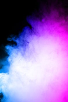 Сlouds of vape fog on black background. At right side thick smoke rising up. Bicolor blue and purple steam in frame. Vape culture and no smoking direction..
