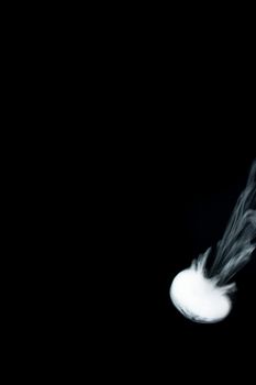 Round ring of vape fog on black background. At right side thick smoke ring goes down.. Vape culture and no smoking direction.