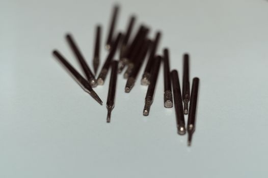 Diamond drill bits on white background. Close-up view. Tools jeweler and dentist.