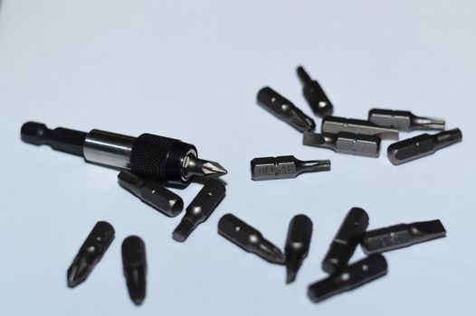 Many tool bits with bitholder on white background.