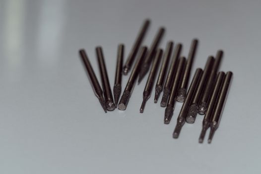 Diamond drill bits on white background. Close-up view. Tools jeweler and dentist.