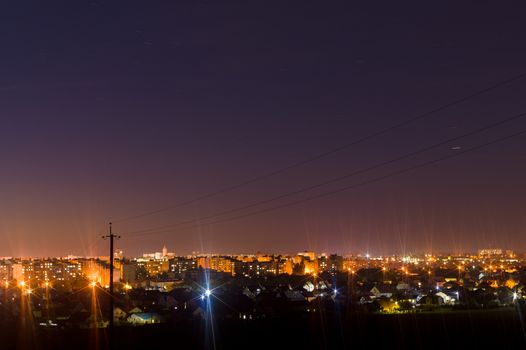 Long exposure night photo. A lot of stars with trees on foreground. Far from the city. Night landscape.