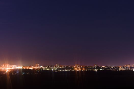 Long exposure night photo. A lot of stars with trees on foreground. Far from the city. Night landscape.