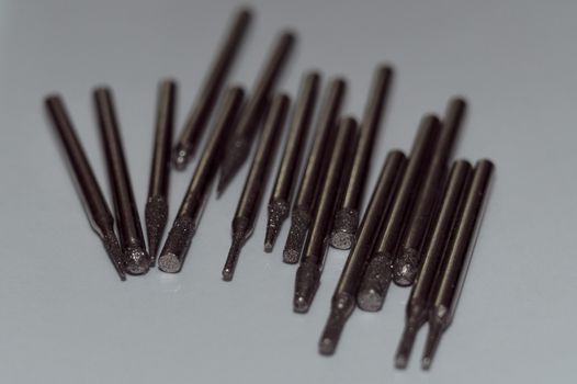 Diamond drill bits on white background. Close-up view. Tools jeweler and dentist.