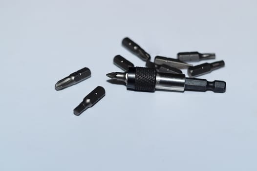 Many tool bits with bitholder on white background.