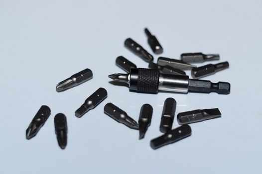 Many tool bits with bitholder on white background.