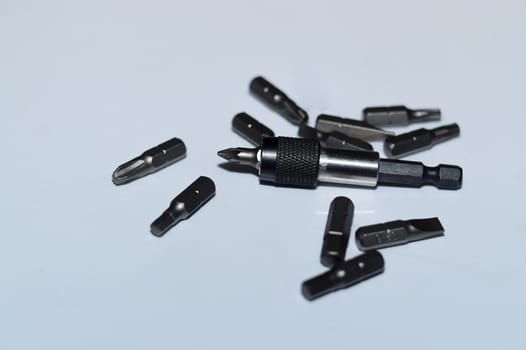 Many tool bits with bitholder on white background.