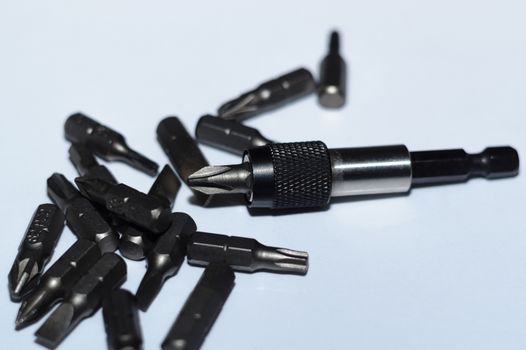 Many tool bits with bitholder on white background.