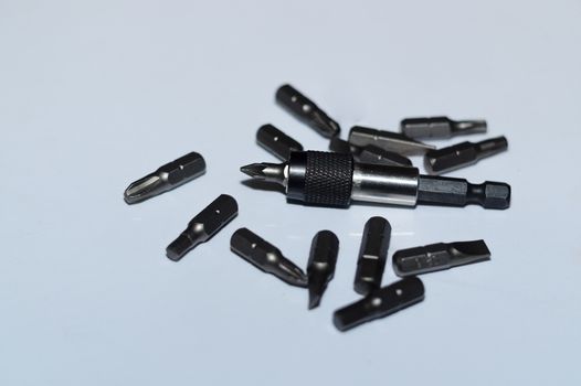 Many tool bits with bitholder on white background.