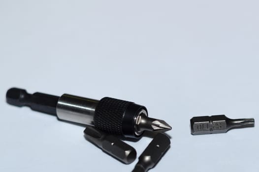 Many tool bits with bitholder on white background.