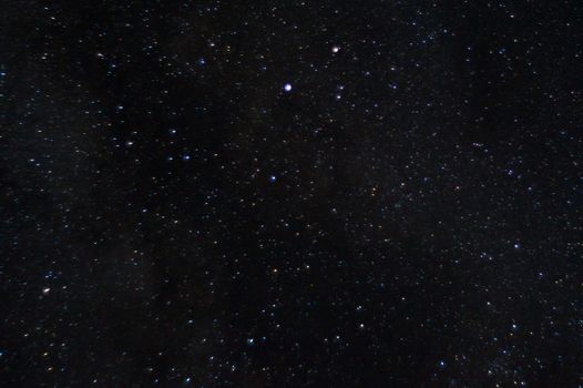 Long exposure night photo of a bright stars. A lot of stars with constellations. Far from the city. Night landscape.