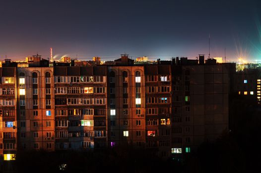 Night long exposure photo 9 and 10 floors high-rise buildings in orange colours. Big city life is here!