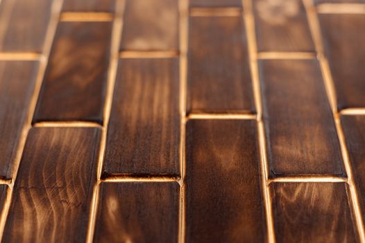 Wooden charred floor of small plates. Bottom view. Floor as an element of the interior.