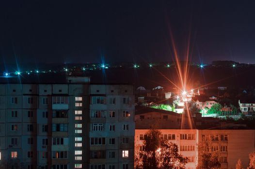 Night long exposure photo 9 and 10 floors high-rise buildings in blue and red colours. Big city life is here!