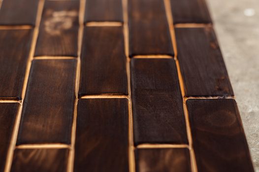 Wooden charred floor of small plates. Bottom view. Floor as an element of the interior.