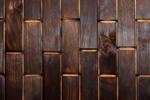 Wooden charred floor of small plates. View from above. Floor as an element of the interior.